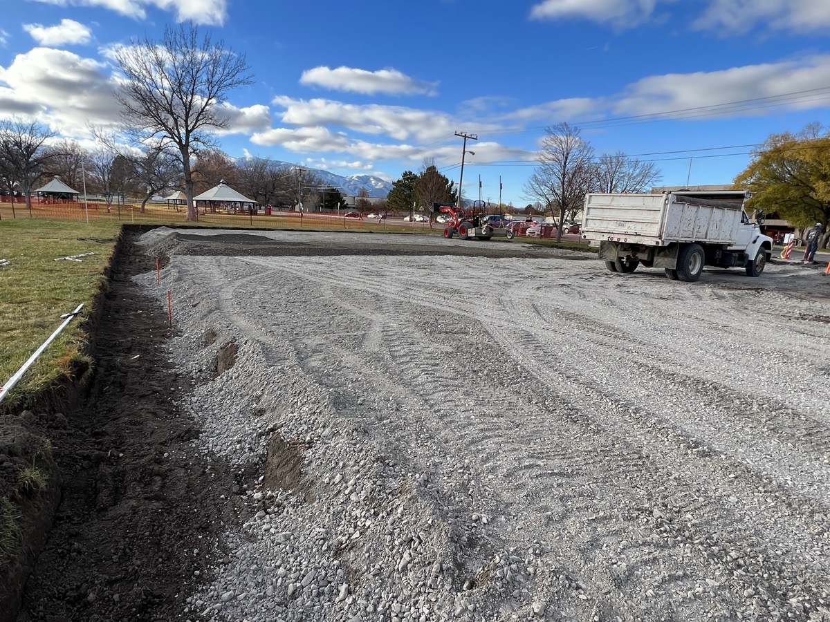 Gravel parking lot grading with dump truck