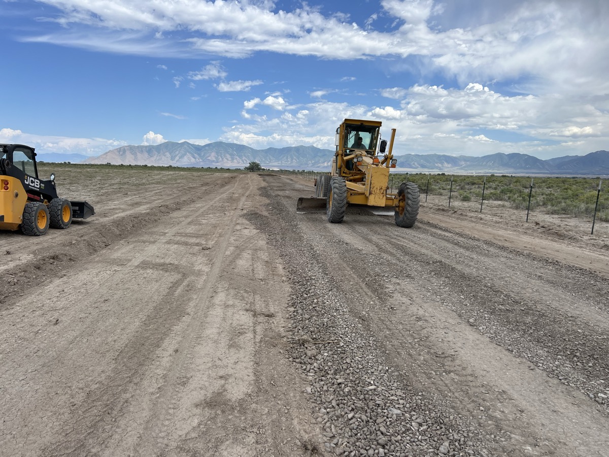 Two pieces of heavy equipment building road