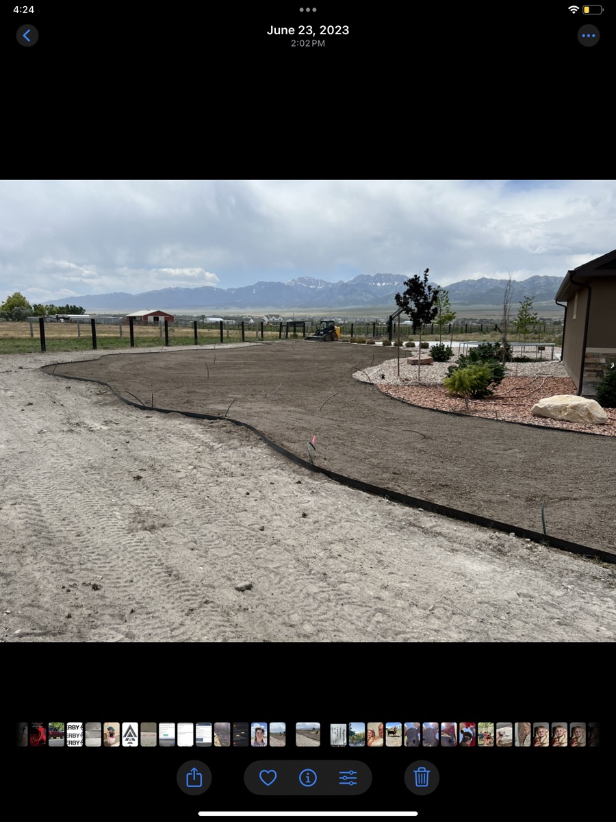 Landscaping build in progress with snowy Wasatch mountains