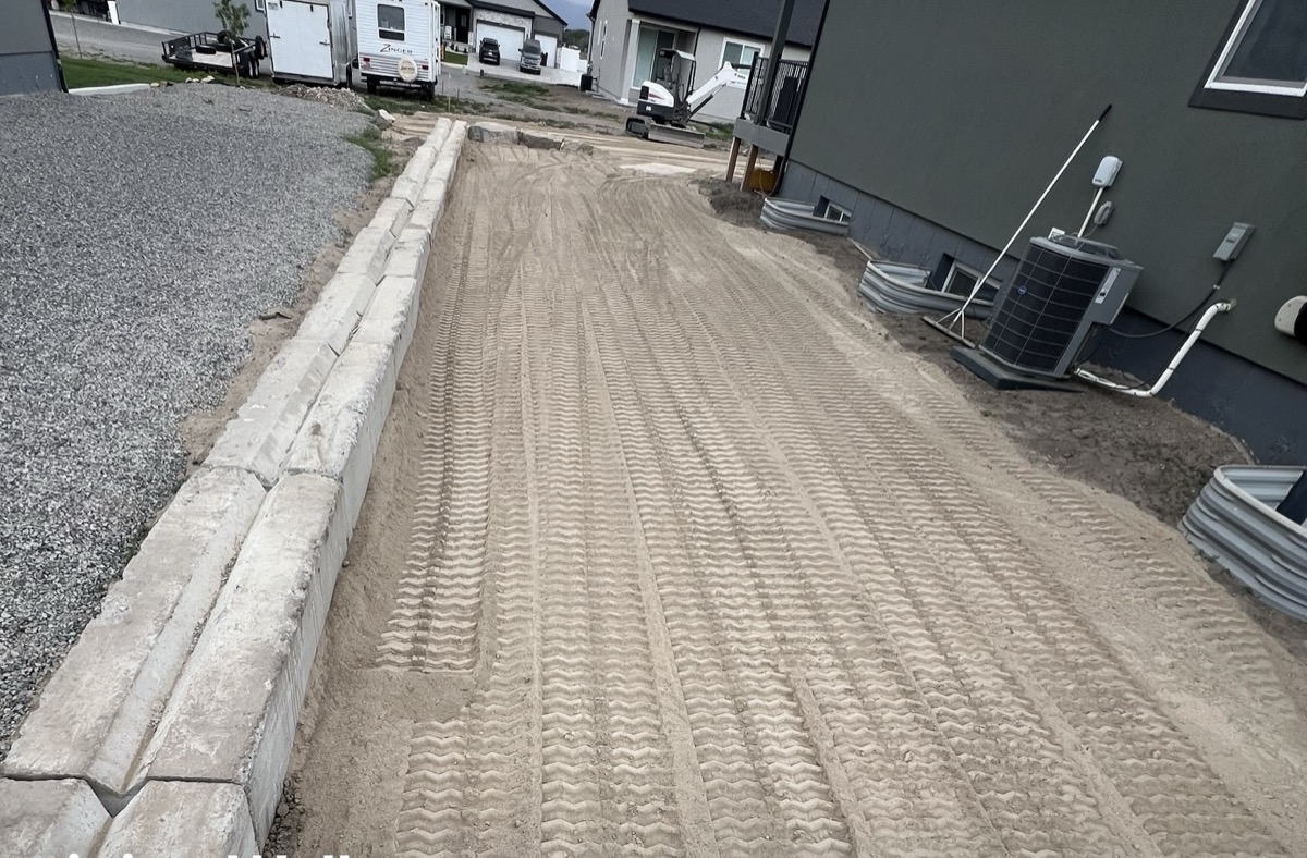 Site prep with retaining wall and graded topsoil