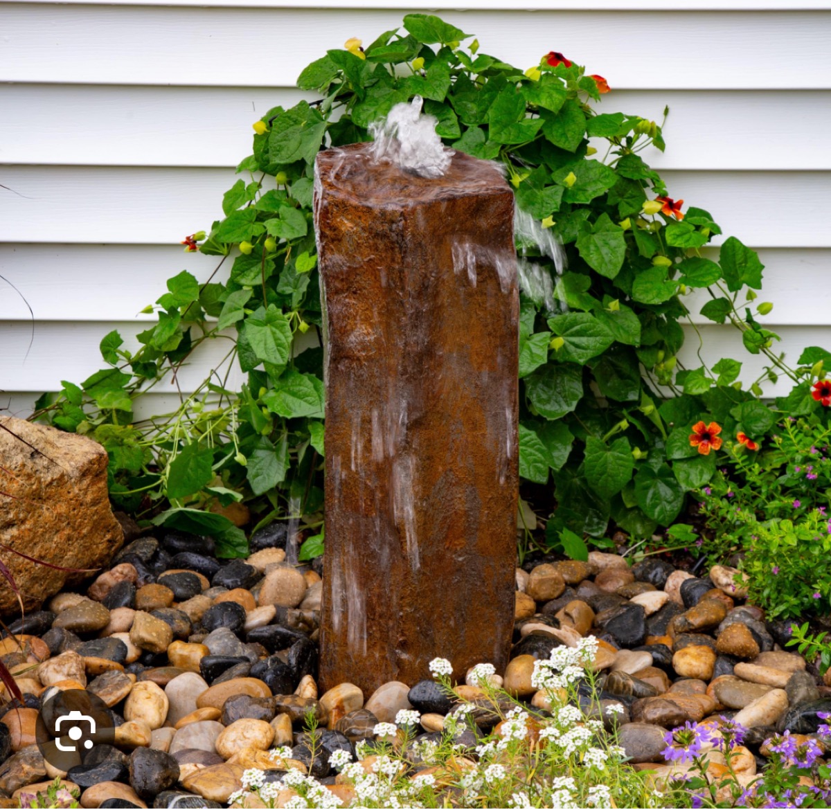 Column stone fountain with flowers